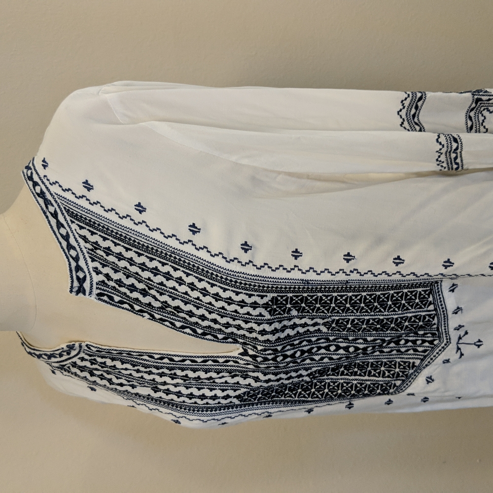 White cotton tunic with dark navy embroidery. Size L